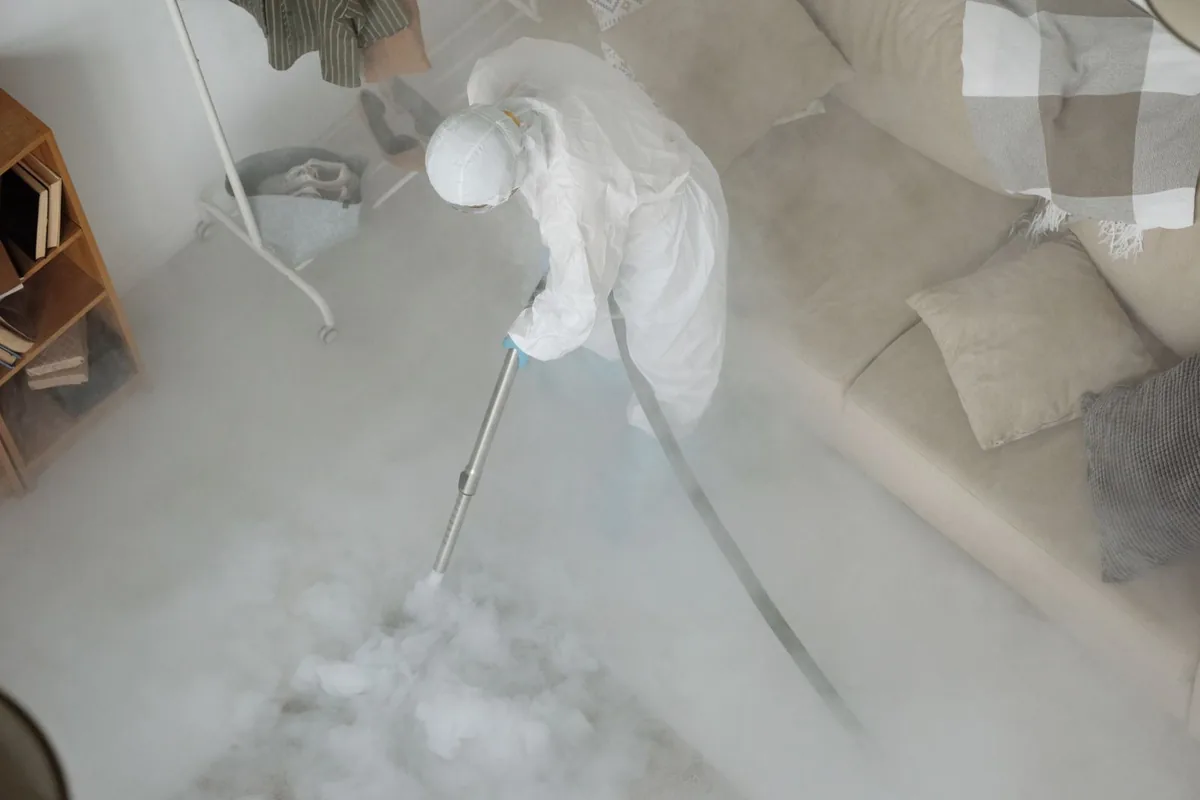 Biohazard cleanup technician in protective equipment, Siesta Acres, TX